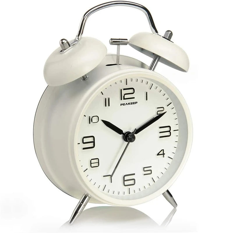 Lumisense twin bell alarm clock on bedside table bedroom setting
