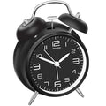 Black twin bell alarm clock with luminous hands for nighttime visibility

