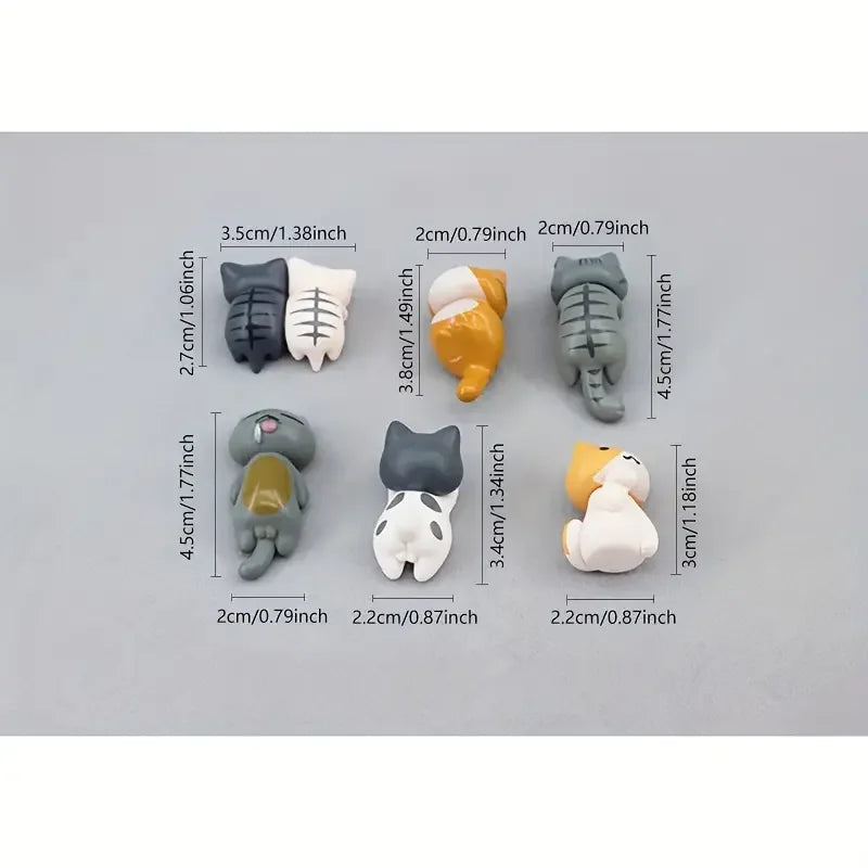 Cute cat figurines displayed on car dashboard for decoration