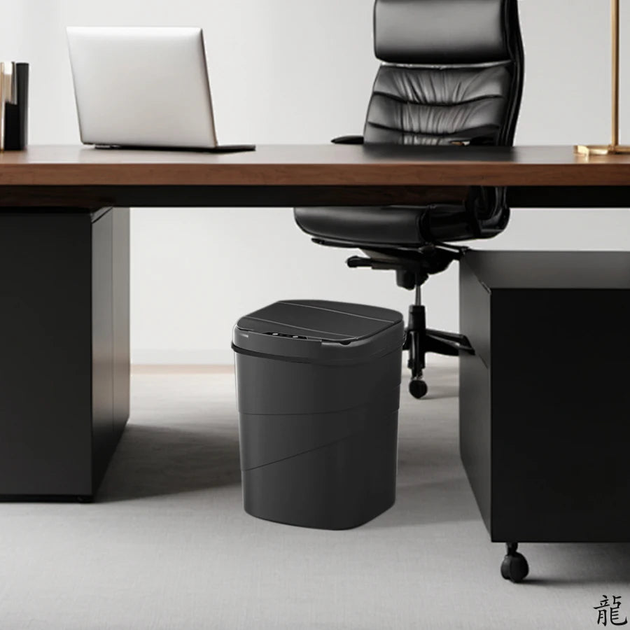 lumisense Black trash can under a desk with a chair in an office setting