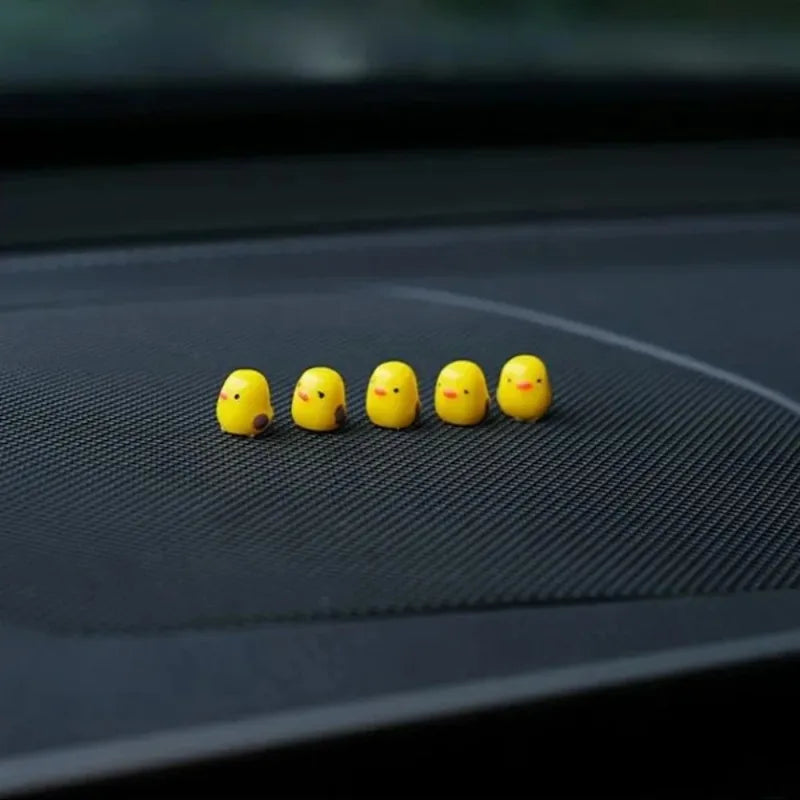 Mini duck ornaments arranged on car dashboard interior
